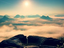 Fantastic sunrise on the top of the rocky mountain with the view