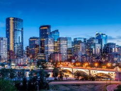 Calgary skyline at night with Bow River and Centre Street Bridge