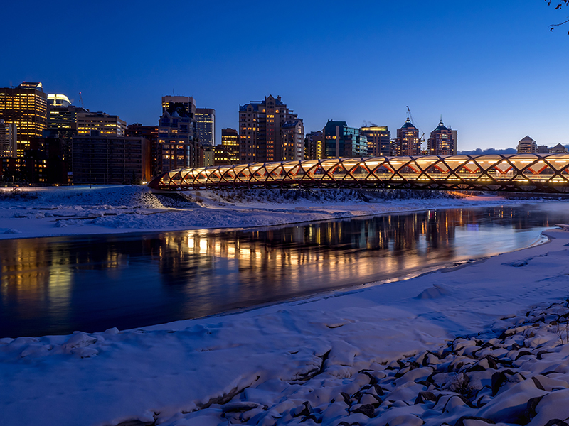 Calgary skyline at night along the Bow River in Calgary, Alberta Canada.