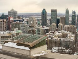 Montreal Skyline in winter and Commemorative Jacques Cartier plaque located on the balustrade of the Kondiaronk lookout on Mount Royal