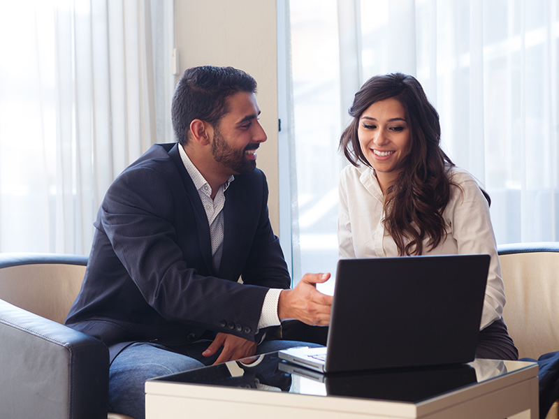 Young business couple meeting with tech devices