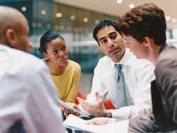 Business People Sitting in an Office Building Having a Meeting