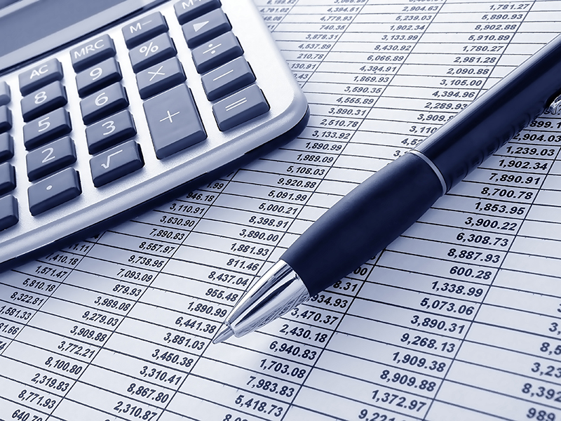 ballpoint ink pen and calculator on a financial spreadsheet statement with columns of numbers for an accounting budget finance reconciliation