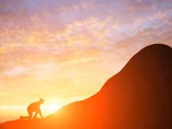 silhouette of business man run on the mountain