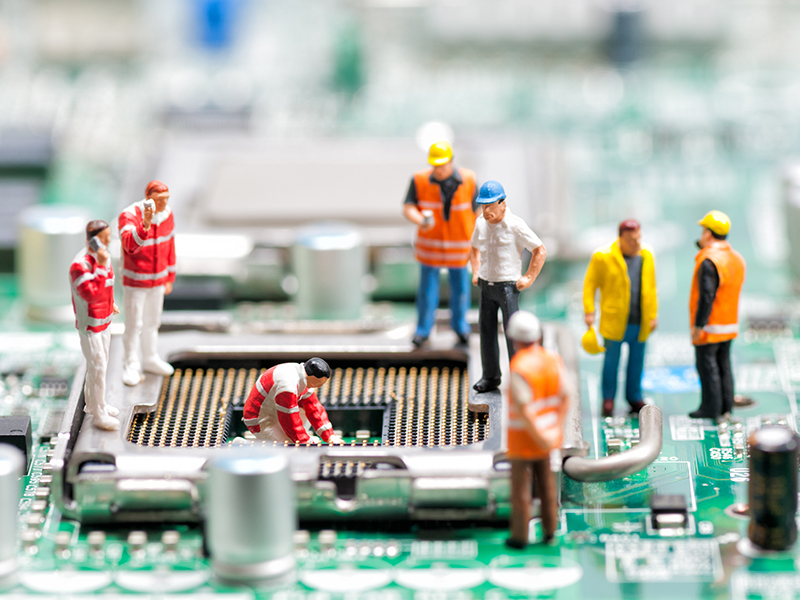 Team of engineers repairing circuit board. Computer repair concept