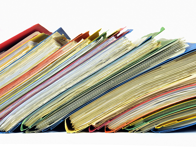 Row of multicolored folders with documents on white background