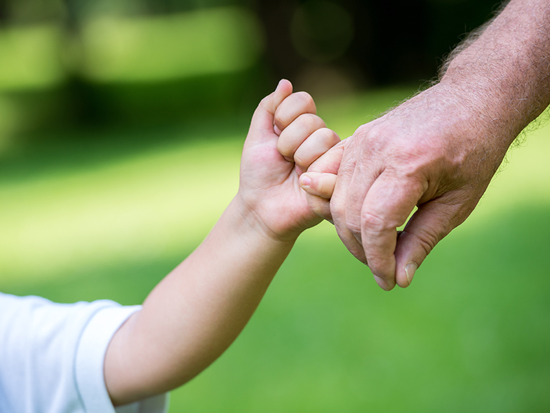 happy grandfather and child have fun and play in park on beautiful sunny day