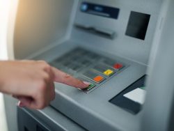 Woman using banking machine. Close up