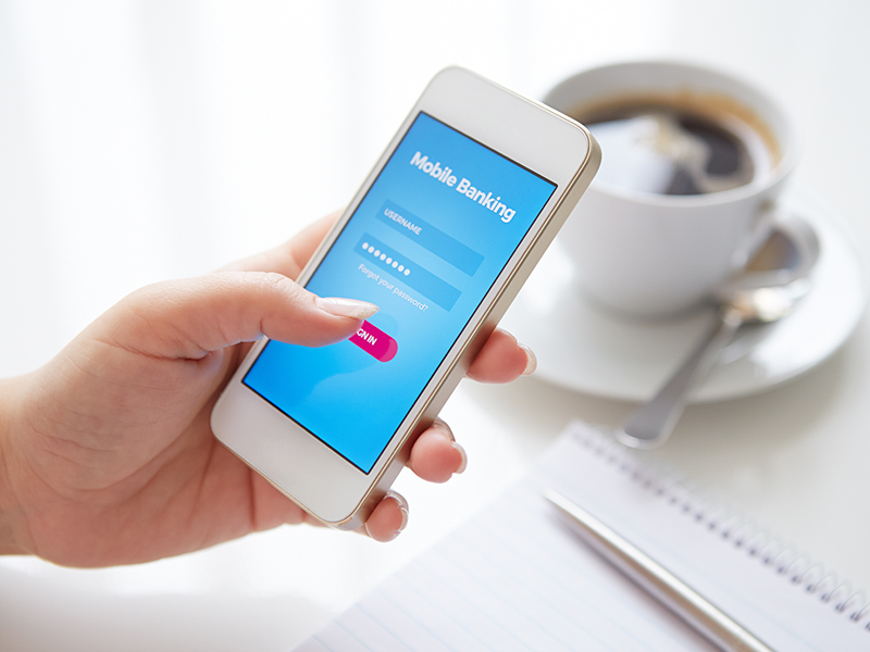 Female hands using mobile banking on white smartphone