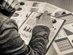 man hand with pen and business report. Accounting