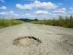 big hole cracked in the asphalt, road view