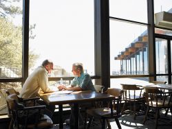 Mature Couple holding hands in restaurant