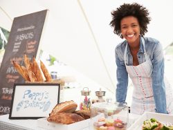 Female Bakery Stall Holder At Farmers Fresh Food Market