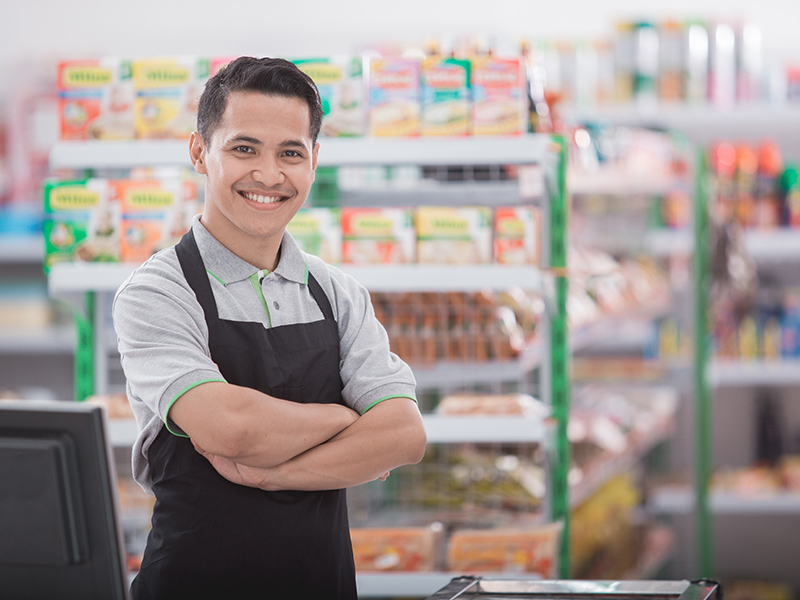 portrait of happy asian male shopkeeper