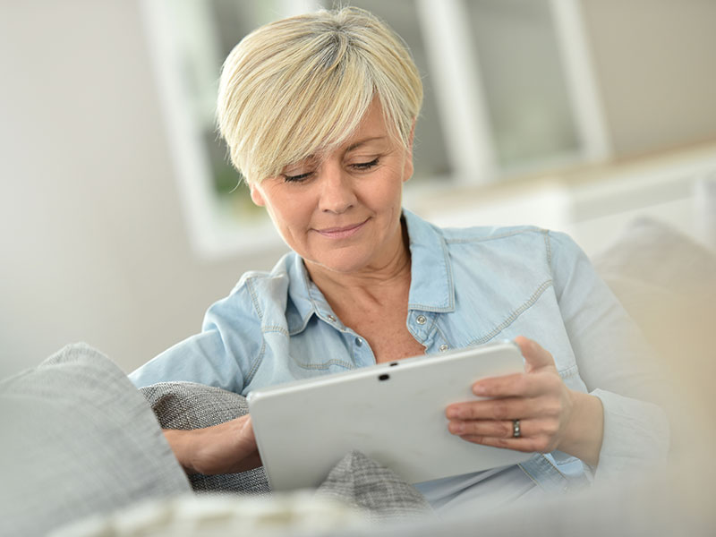 Senior woman websurfing on digital tablet