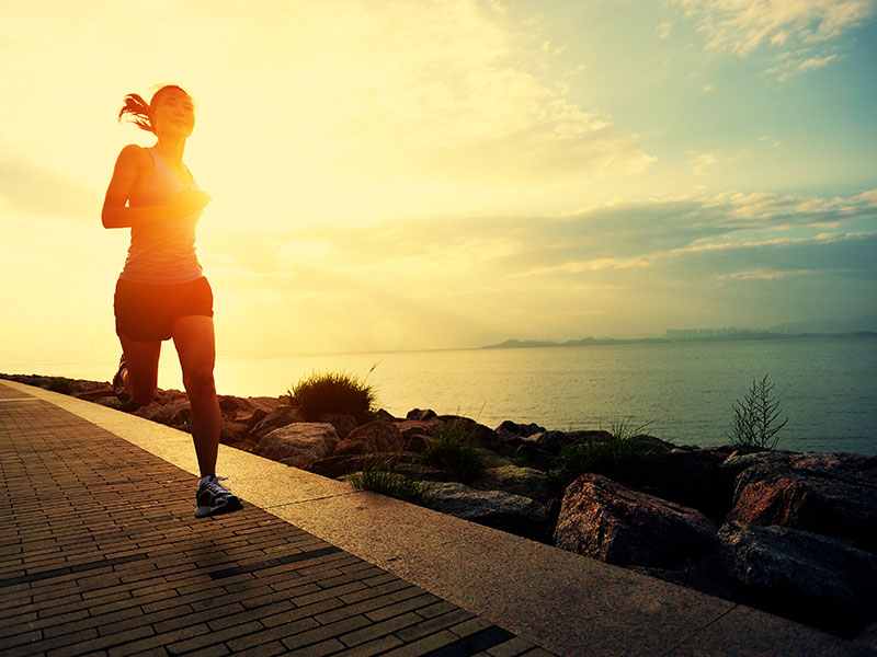 Runner athlete running at seaside. woman fitness silhouette sunrise jogging workout wellness concept