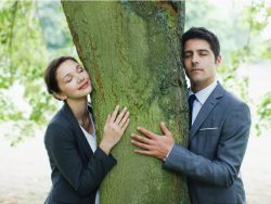 Business people hugging tree stock photo