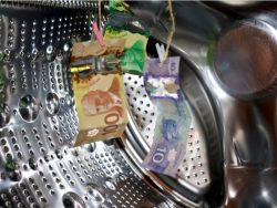 Money hanging in a washing machine, laundering